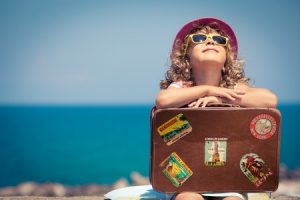 38259947 - child with vintage suitcase on summer vacation. travel and adventure concept